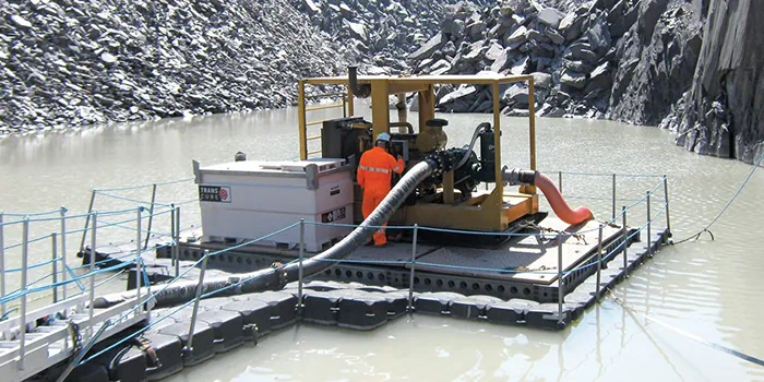 Floating diesel dewatering pump station mounted on a barge to minimize suction lift constraints in an open-pit mine.