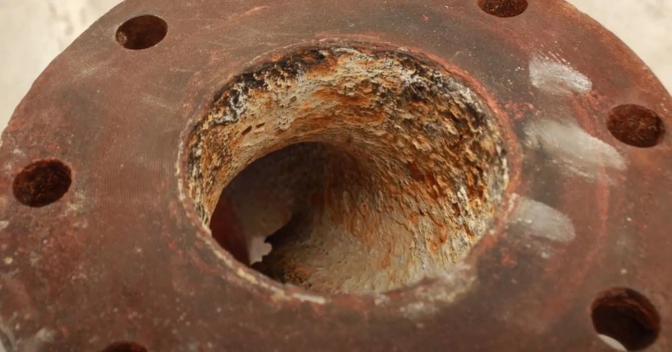 Severe abrasive erosion and volute washout inside a pump casing, caused by pumping sand with a standard iron trash pump.
